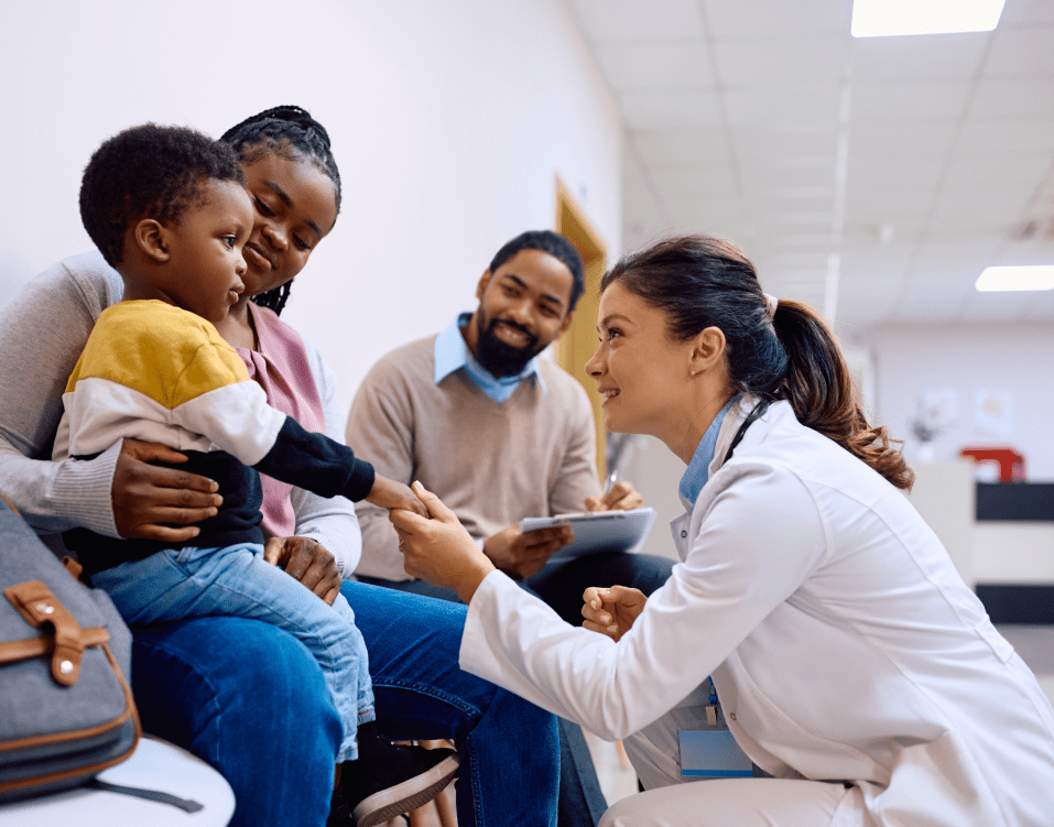 Doctor examines a young child in clinic.